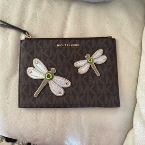 Michael Kors Large Wristlet 
Almost new 
Size-9.5 x 7 inches 
Card slots inside